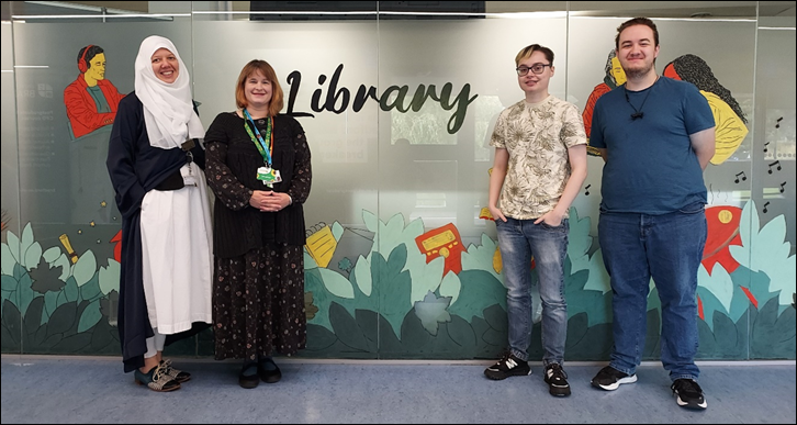 Figure 1
Library mural with artists (left to right) Aicha Bahij (lead), Louise Dawson, Emily Cowler, and Sean Temple.
