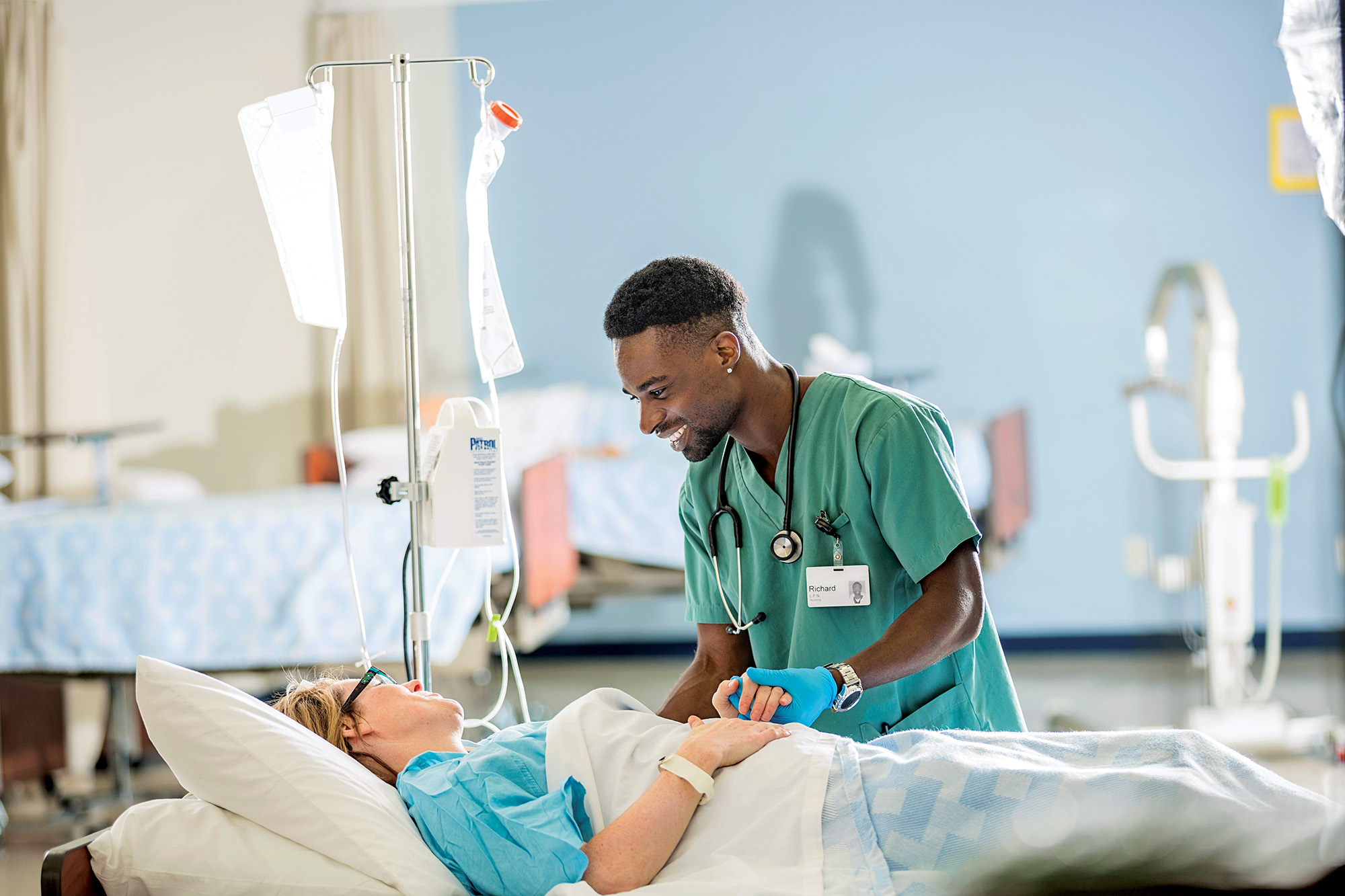 Image of nurse, speaking with a patient.